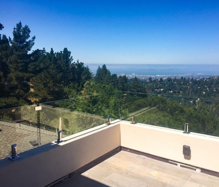 Frameless glass railing with top clips on a back porch overlooking Los Angeles