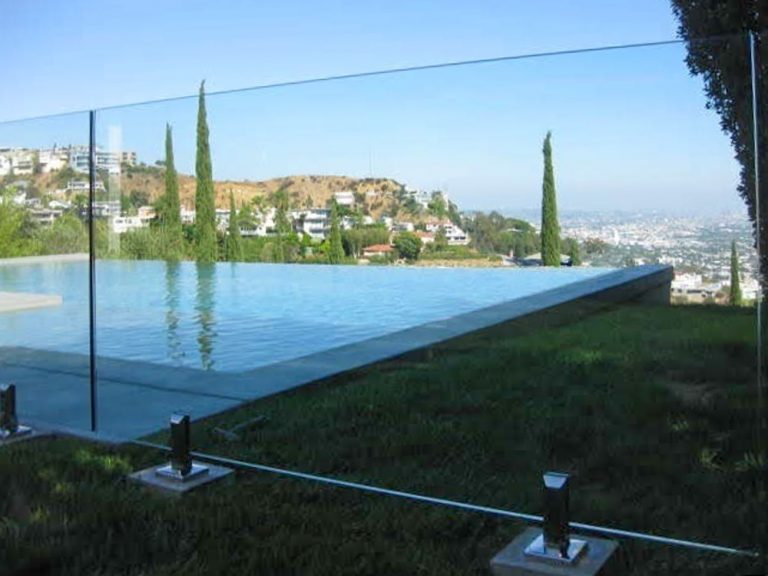 glass pool fence in a backyard overlooking Los Angeles.