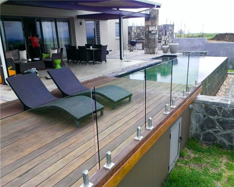 Glass railing balcony mounted to a wooden porch