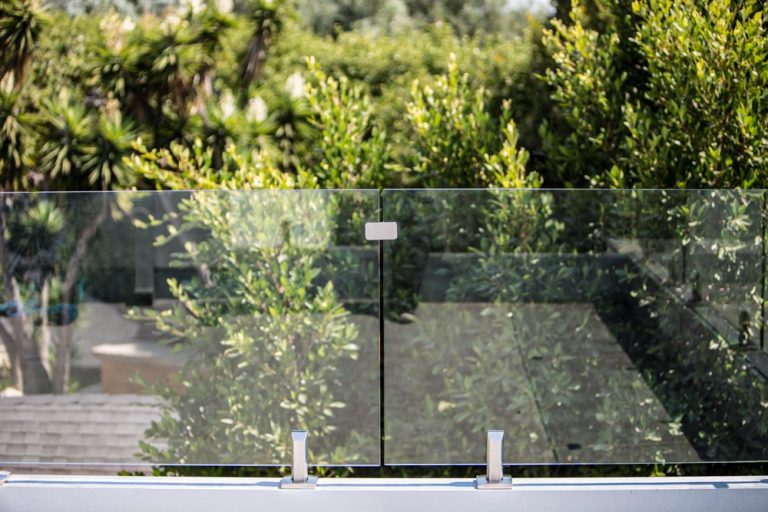 two glass railing panels on a rooftop balcony