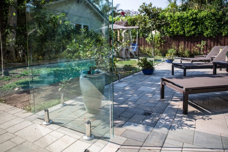 Frameless glass fence in a back yard on concrete