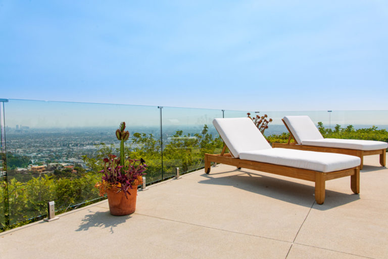 Glass fencing on a concrete balcony overlooking los angeles