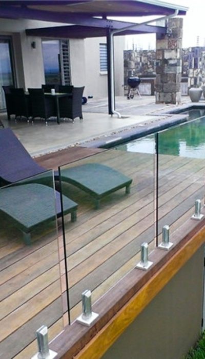 Glass railing balcony mounted to a wooden porch